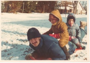 My dad sledding with Bill and me