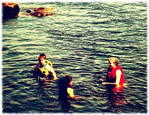 Susanna and the boys playing in the water.