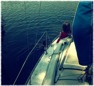 Susanna watching Will swim next to the boat. Anchored on the Thames River in Gales Ferry, CT (just north of the Yale boathouse)