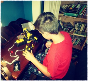Will playing with his robot arm after completing the project.