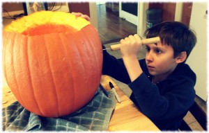 Ben working on carving his pumpkin.