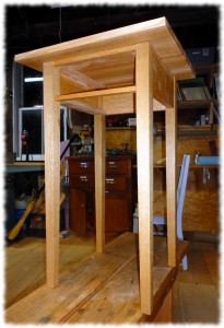 Nightstand after glue-up. The top is just resting on the base. An initial coat of shellac has been applied to the table