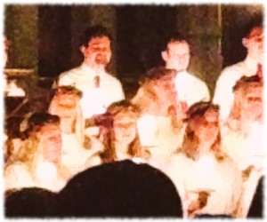 Susanna (bottom right) singing by candlelight at the Lucia celebration