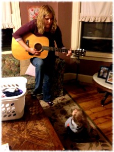 Susanna singing to Michael in the living room. I'm pretty sure I need to tune the guitar, but Michael didn't seem to mind.