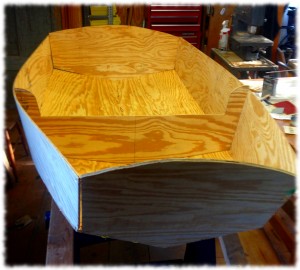 The rough shape of the boat begins to form with all the major pieces stitched in place.