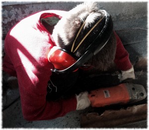 Ben spending time with the sander on the bottom of his boat.