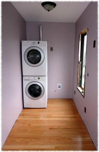 Laundry/Mud Room with the walls painted, floor installed and washer and dryer.