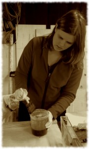 Susanna putting a varnish finish on the second toy box for her preschool.