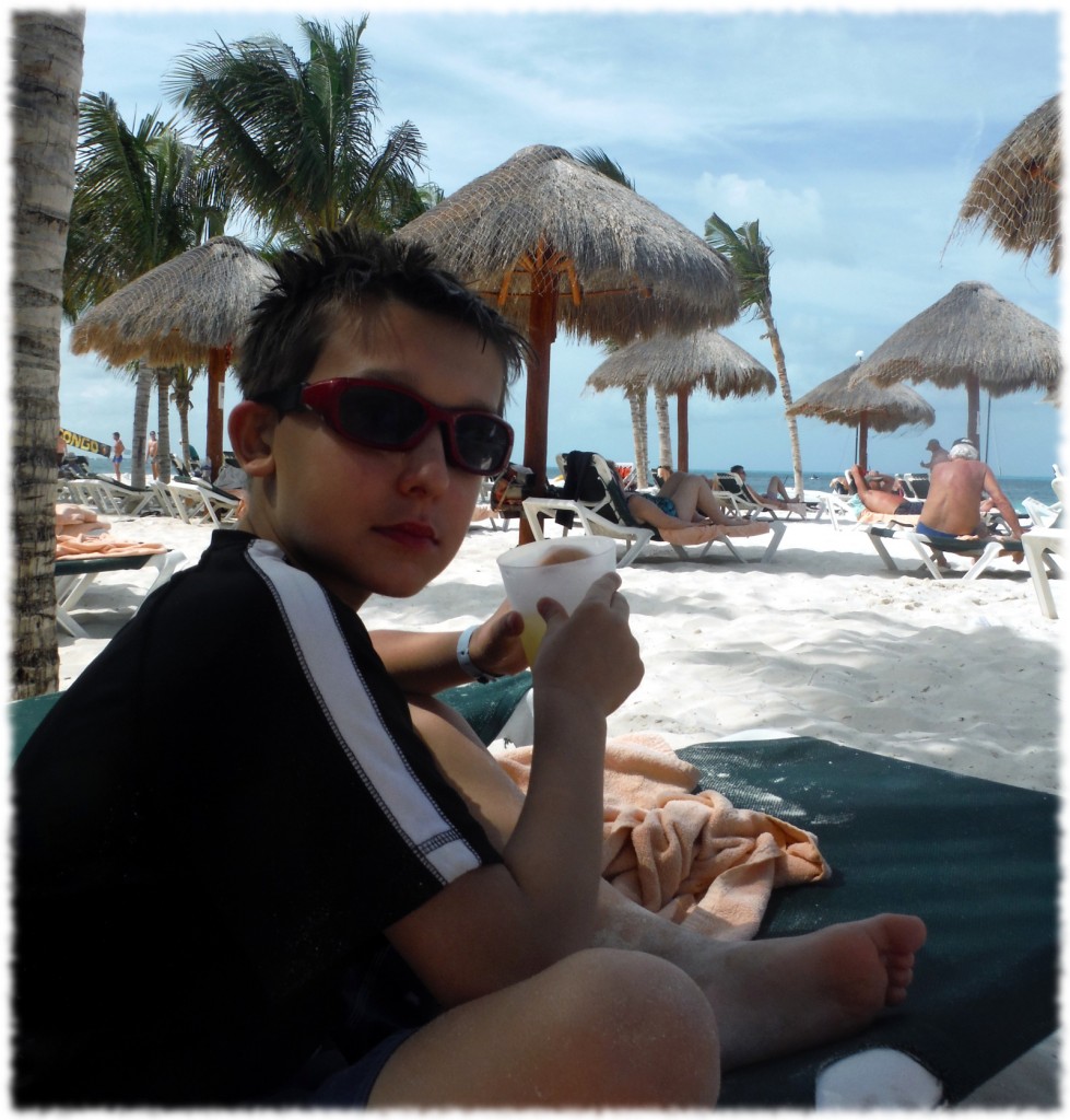 Benjamin enjoying his drink by the beach (and not too happy to be the subject of the photograph)