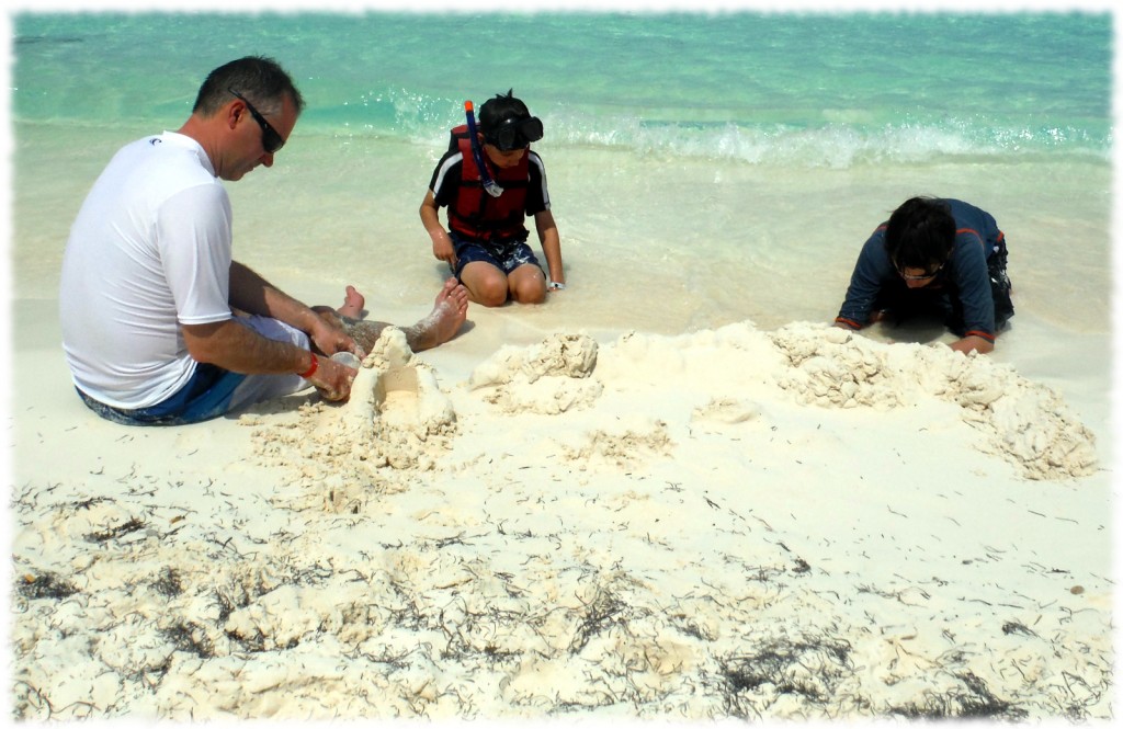 Making sand castles in the white sand on the beach in Cancun.