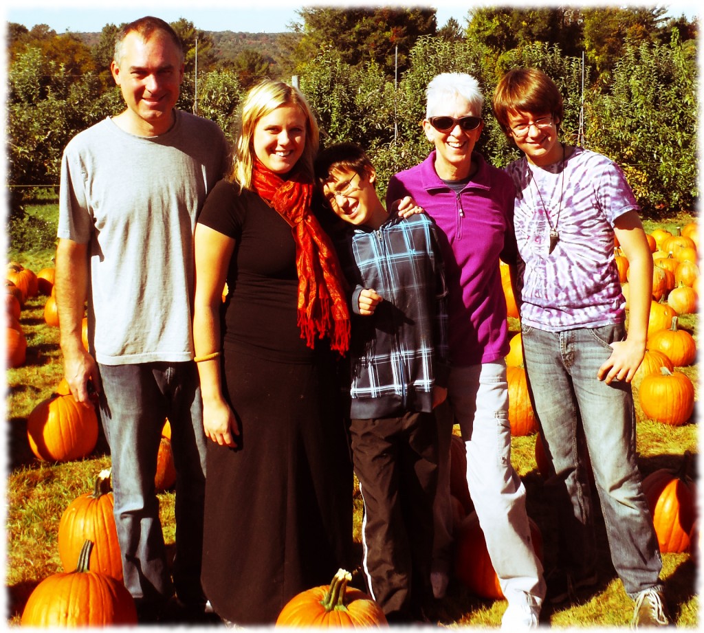 The whole family enjoying the perfect fall weather at the apple orchard.