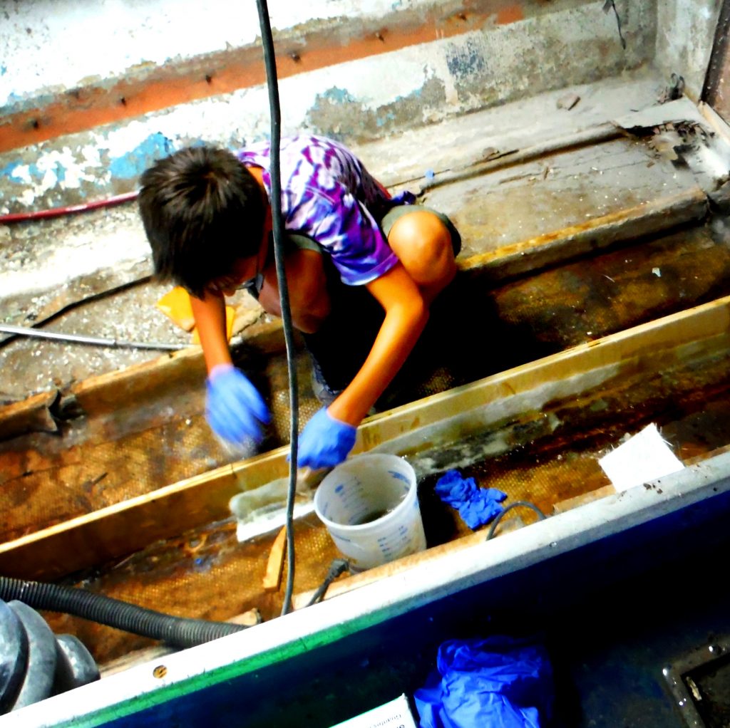 Ben working the resin into the fiberglass matting.