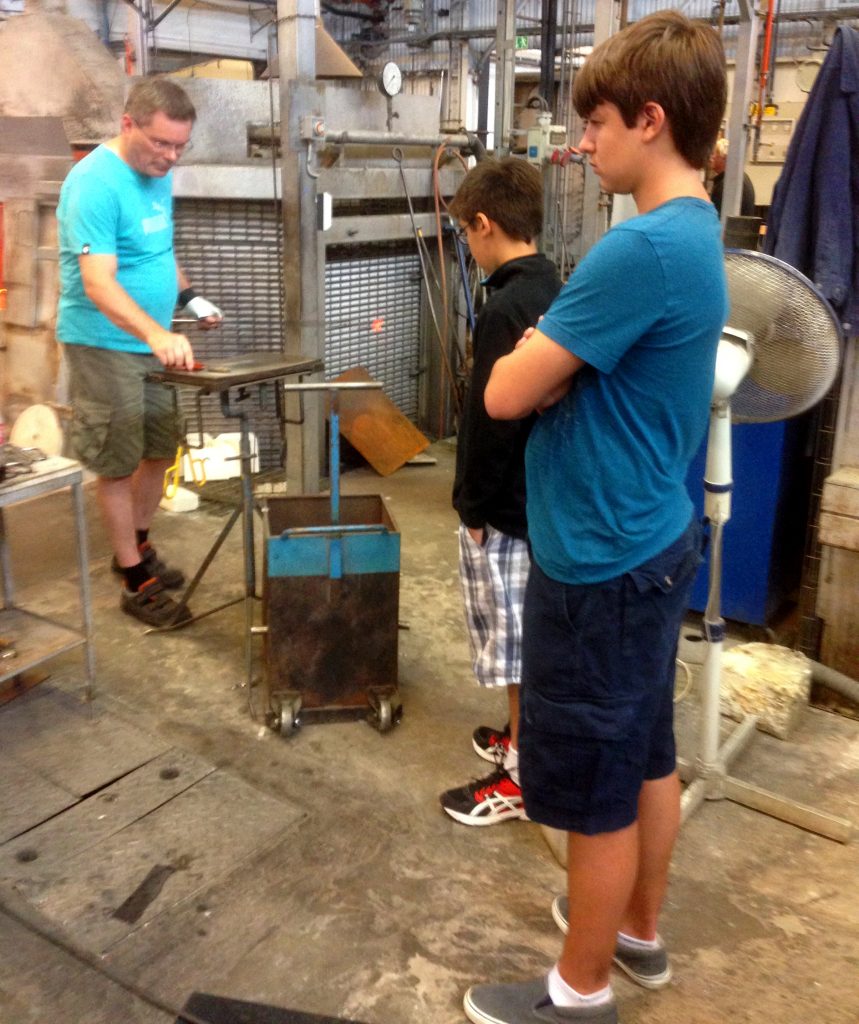 Will and Ben watching the glass blowers work at Kosta, Sweden.