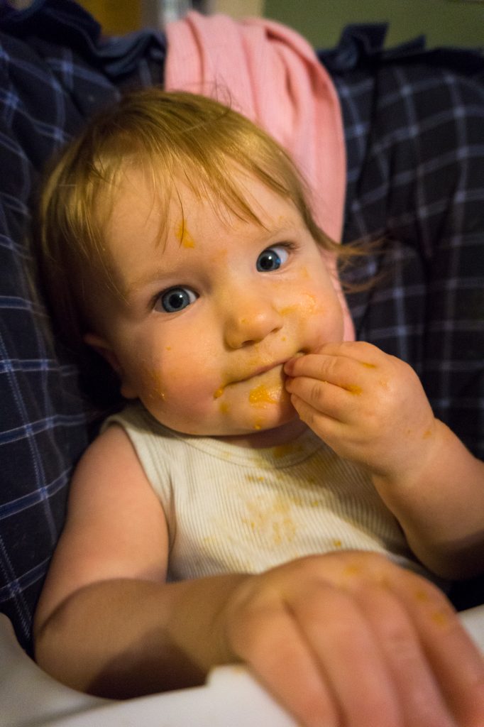 Wearing almost as much as eating her sweet potato dinner.