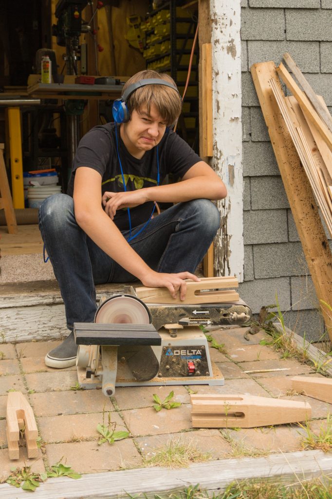 Will working on sanding the legs for the bed frame he and I are making together. Always happy to be the subject of the camera.